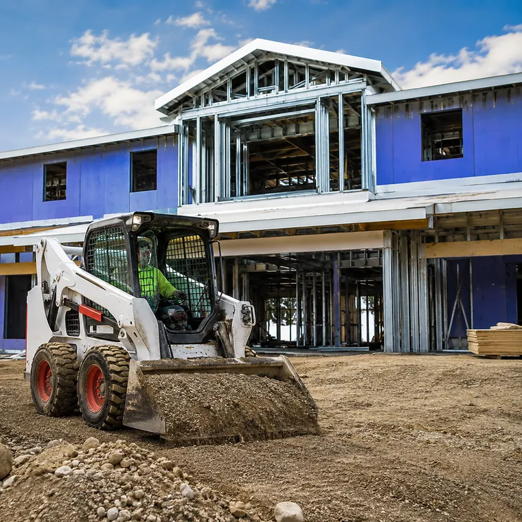 Commercial construction with skid-steer equipment in progress